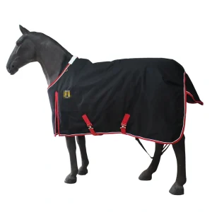 Winter horse blanket in black with red trim on a model horse