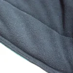 Soft black fabric of a winter horse blanket with smooth texture