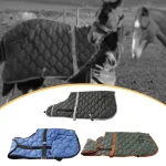 Winter horse blankets in various colors displayed on horses in a pasture.